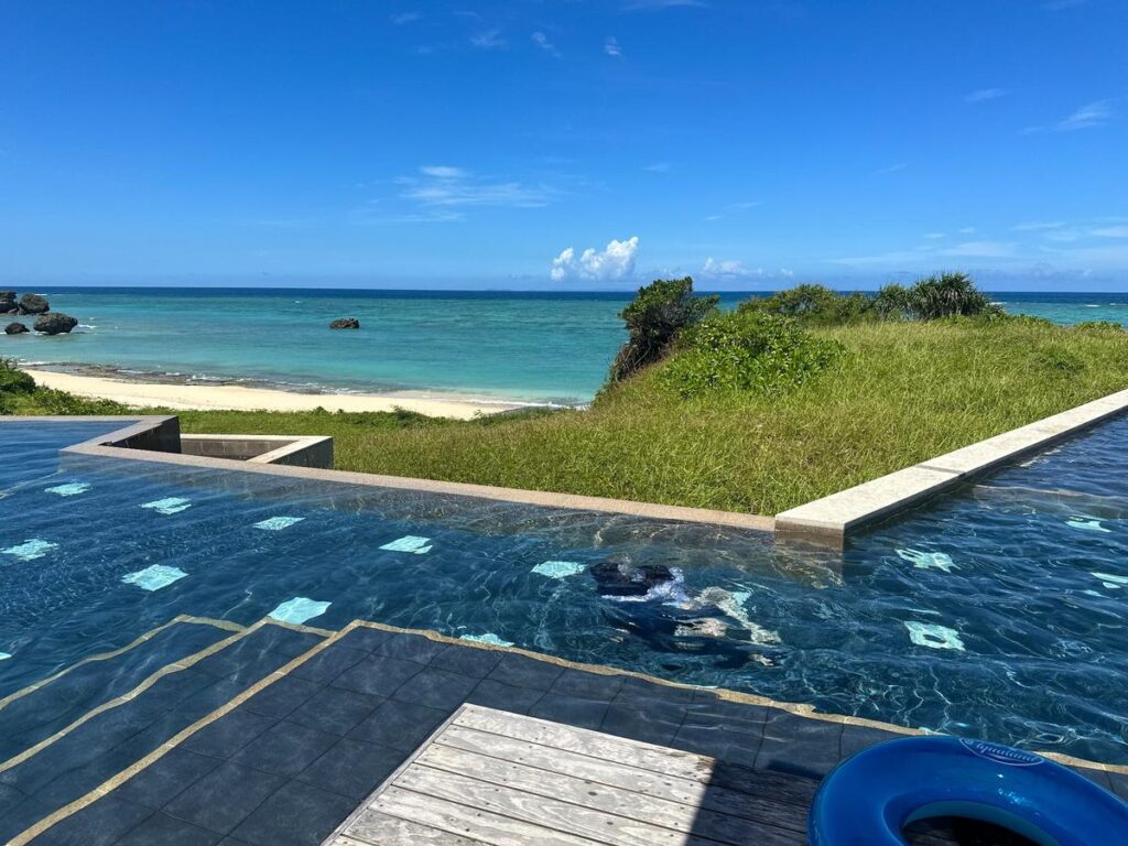 沖縄の海を望むインフィニティプールと青空の絶景